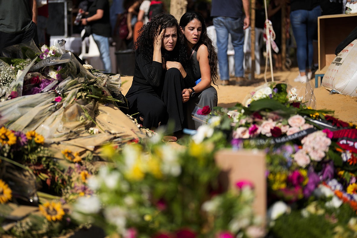 Mourners attend the funeral of David Caroll at Kibbutz Revivim, southern Israel, October 22, 2023