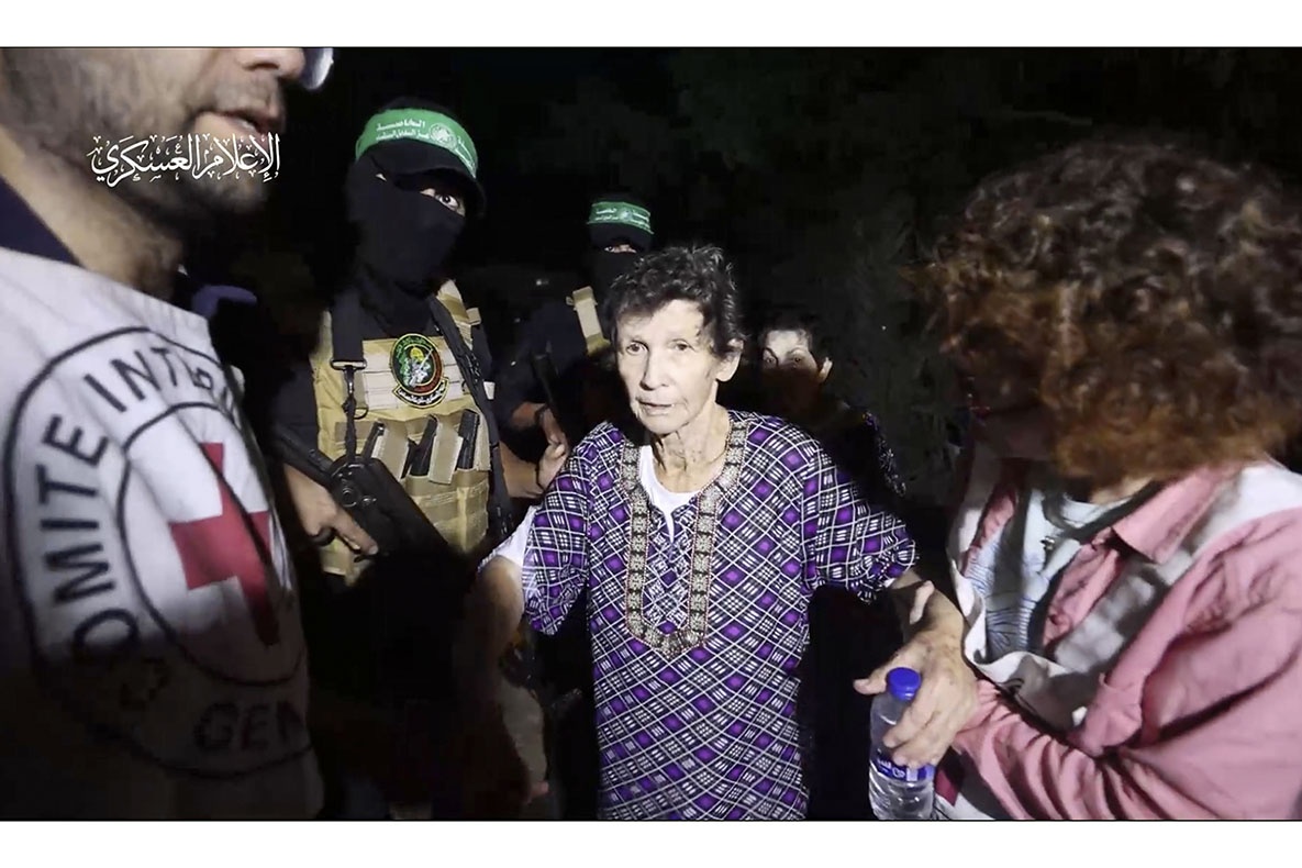 This image taken from video released by Al Qassam brigades on its Telegram channel, shows Yocheved Lifshitz, 85, shaking hands a thanking a member of Hamas as she is released to the Red Cross in an unknown location, October 23, 2023