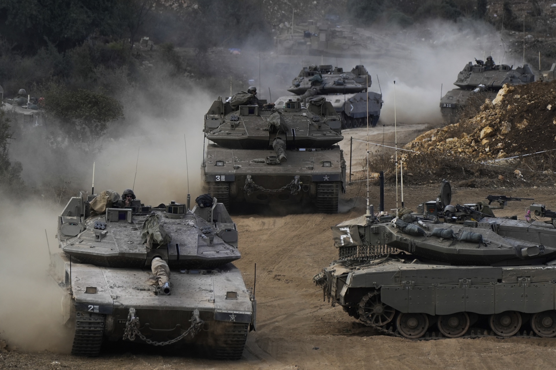 Israeli tanks maneuver in a staging area in northern Israel near the Israel-Lebanon border, October 1 2024